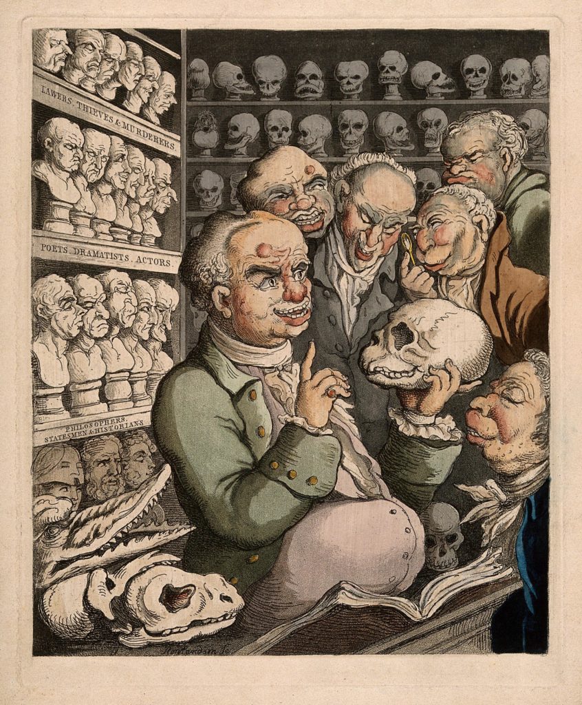 Satiretegning af Franz Joseph Gall sammen med sine frenologikollegaer, omgivet af hans store samling af kranier og gipsafstøbninger. Farvet af T. Rowlandson, 1808. Wellcome Collection.